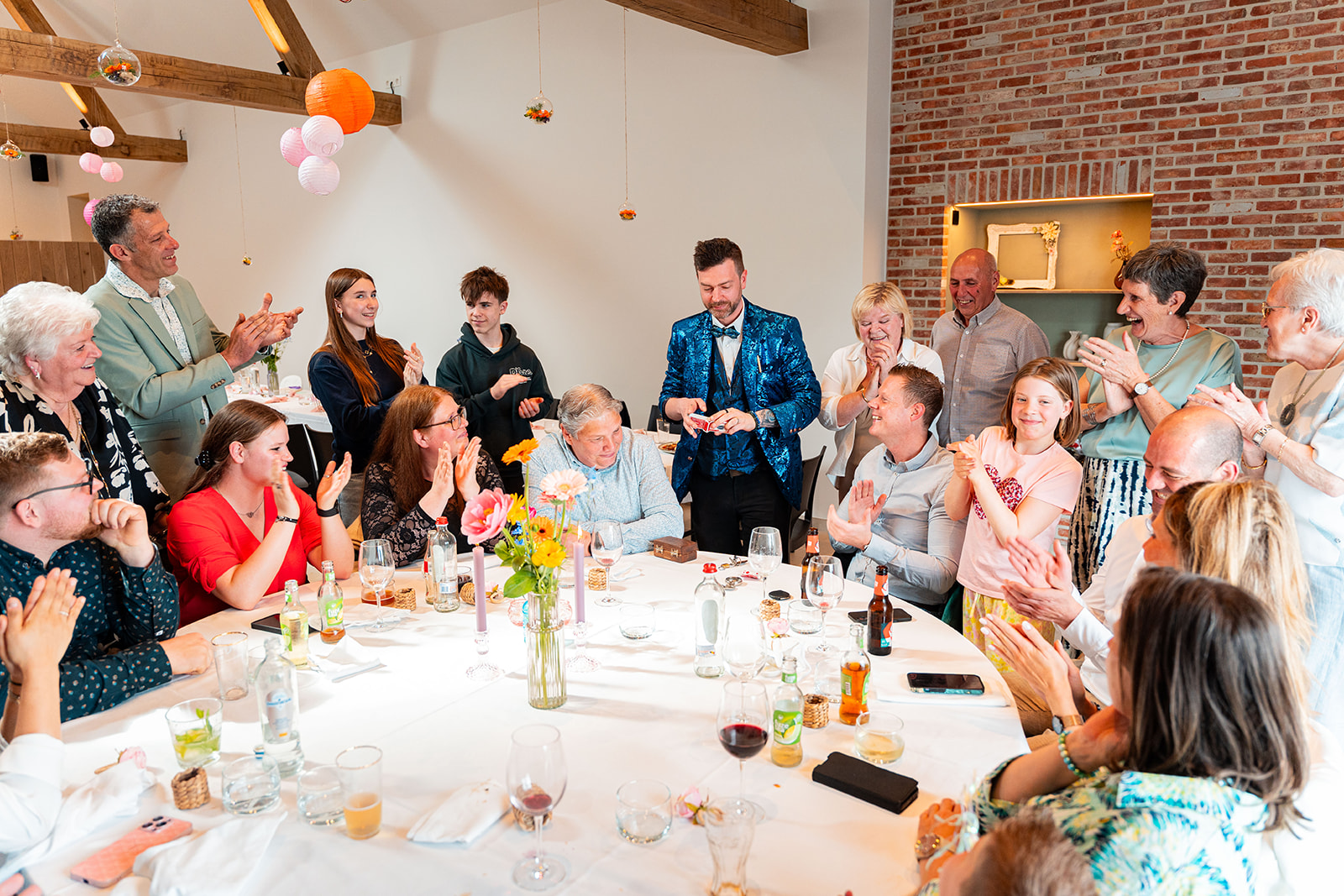 Volle feestzaal applaudisseert voor goochelaar na geslaagde act